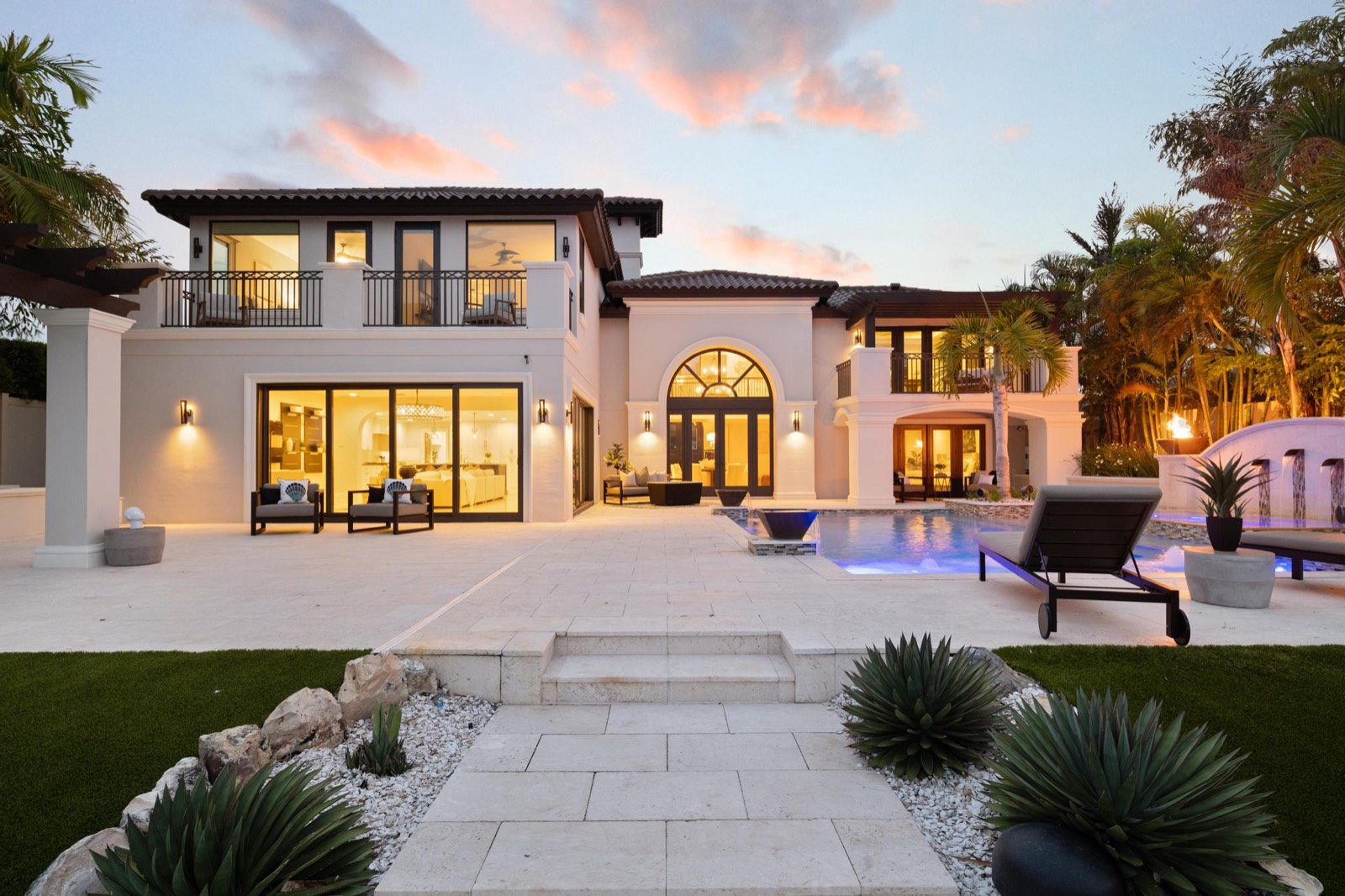 Mediterranean-style home exterior photographed at twilight in Tampa Bay